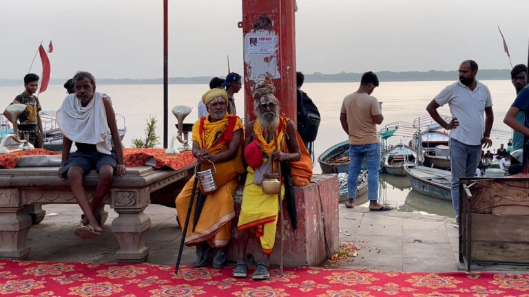 Sadhus meditating beside Ganges river at Varanasi